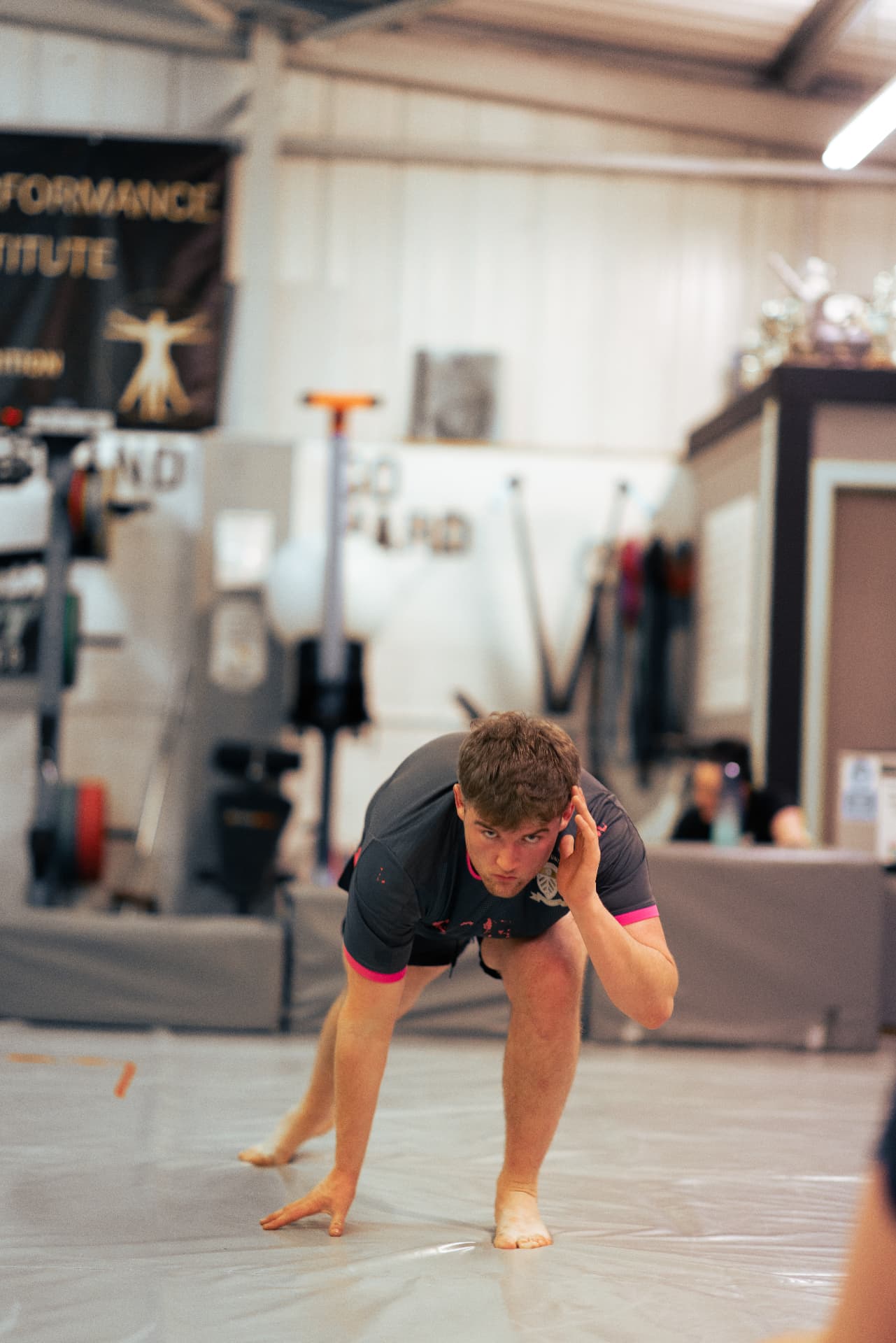 Grappler in a low stance during a BJJ session