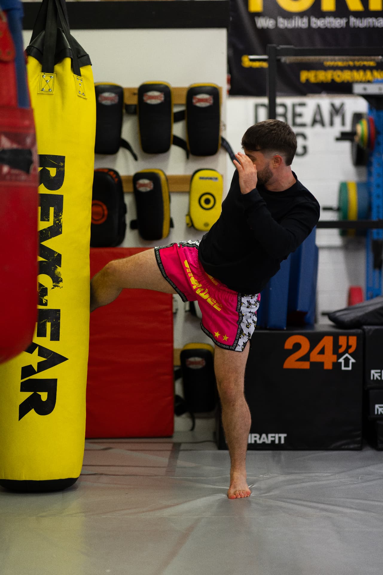 Fighter landing a heavy kick on the bag at Chokdee